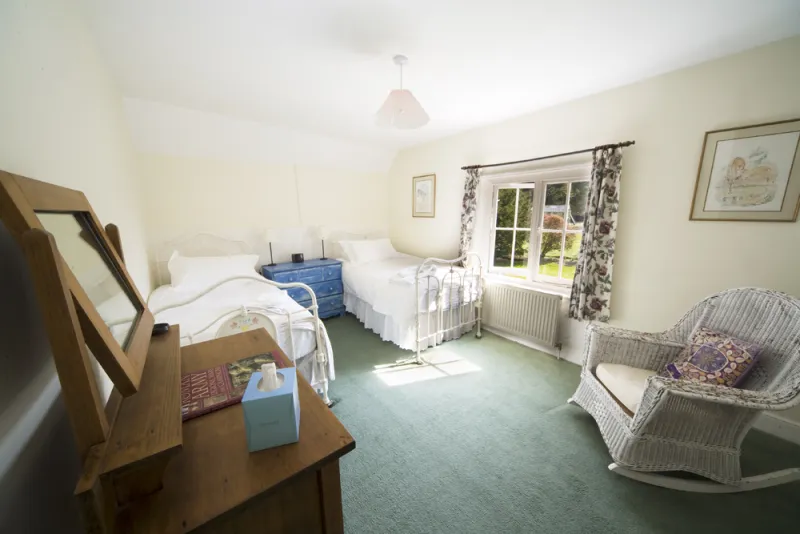 A bright twin bedroom overlooking the garden