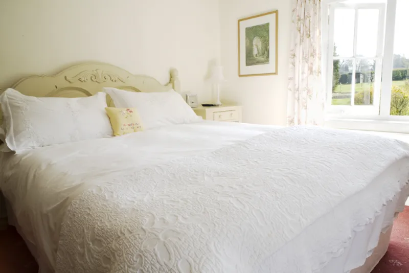 A light-filled double bedroom looking over the fields